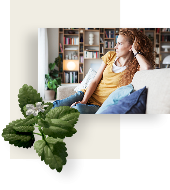 Red hair woman on a couch, looks left.