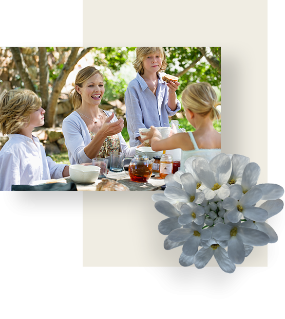 Woman having a meal with her children in a garden.