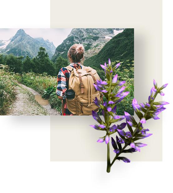 Woman walking a mountain valley, with her backpack.