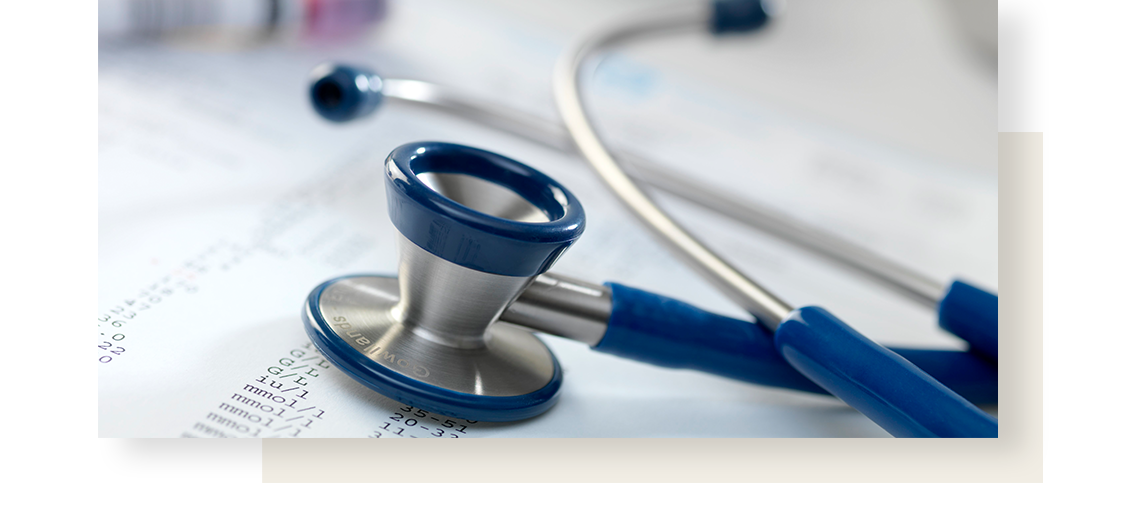 Stethoscope with blues rubber parts, lying on a sheet of data regarding irritable stomach.