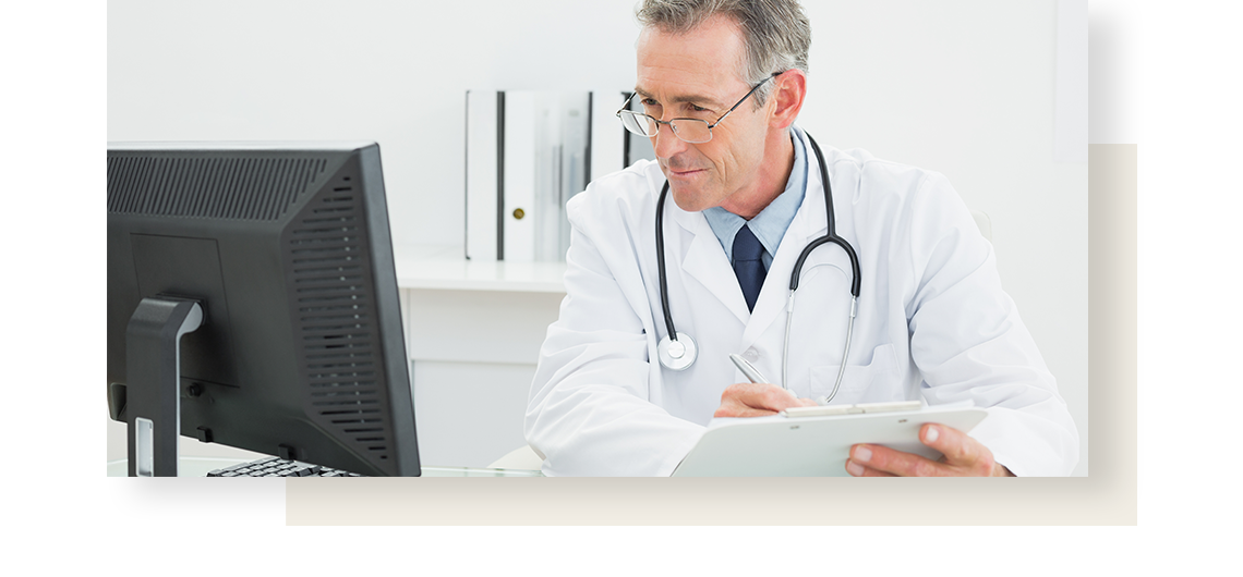 A doctor looking at a monitor and making notes