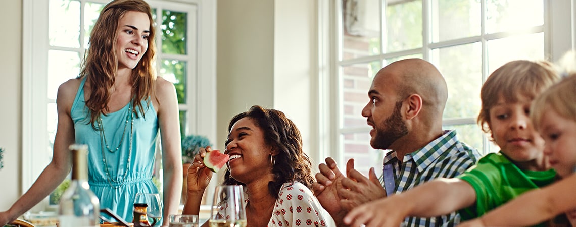 A family enjoying their meal in bright room.