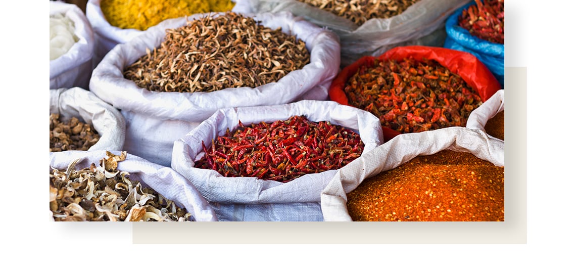 Colourful spices in big sacks, displayed on a street market.