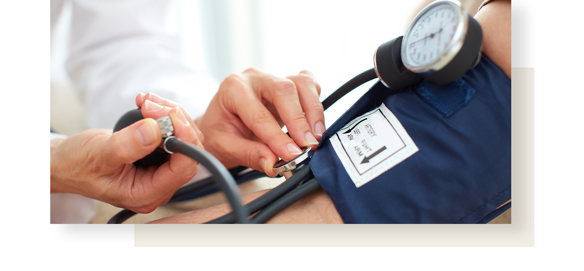 Close-up on a physician, examining patient blood pressure.