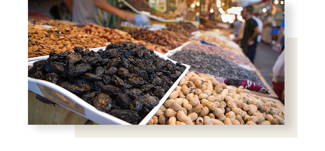 Delicacies on a market stroll: peanuts, almonds, dried plums and more.